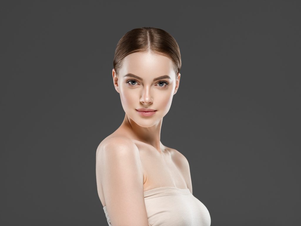 Beautiful face woman healthy skin gray background