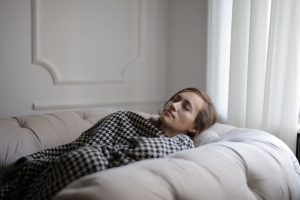 Mujer descansando en el sofá durante el postoperatorio